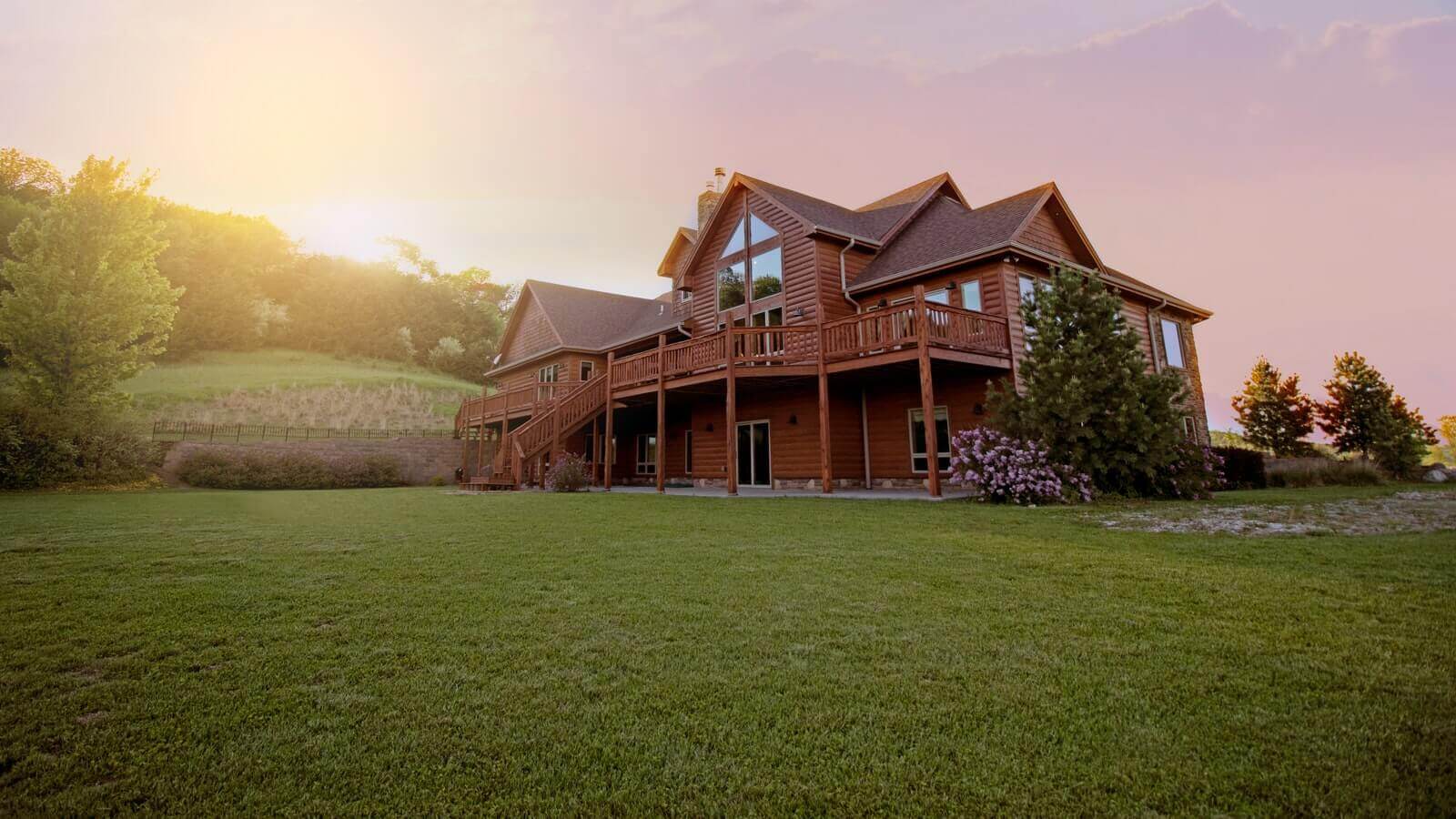 A beautiful home with the sun rising in the background.